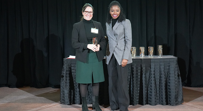 Jenny Brady of ProAmpac holds an award the company received from Christine Taylor of Medical Mutual.